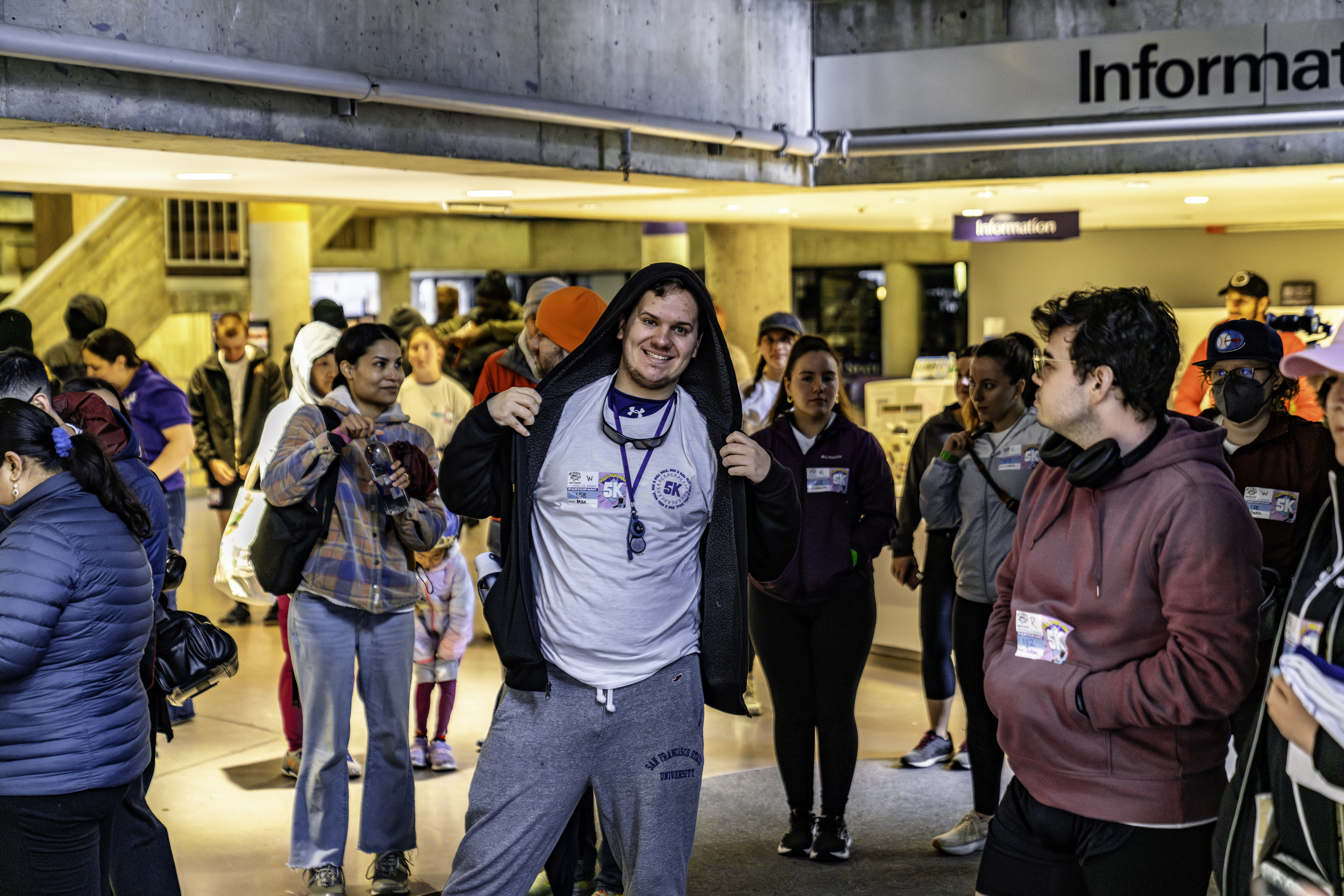 Student poses in front of group at Annual 5K