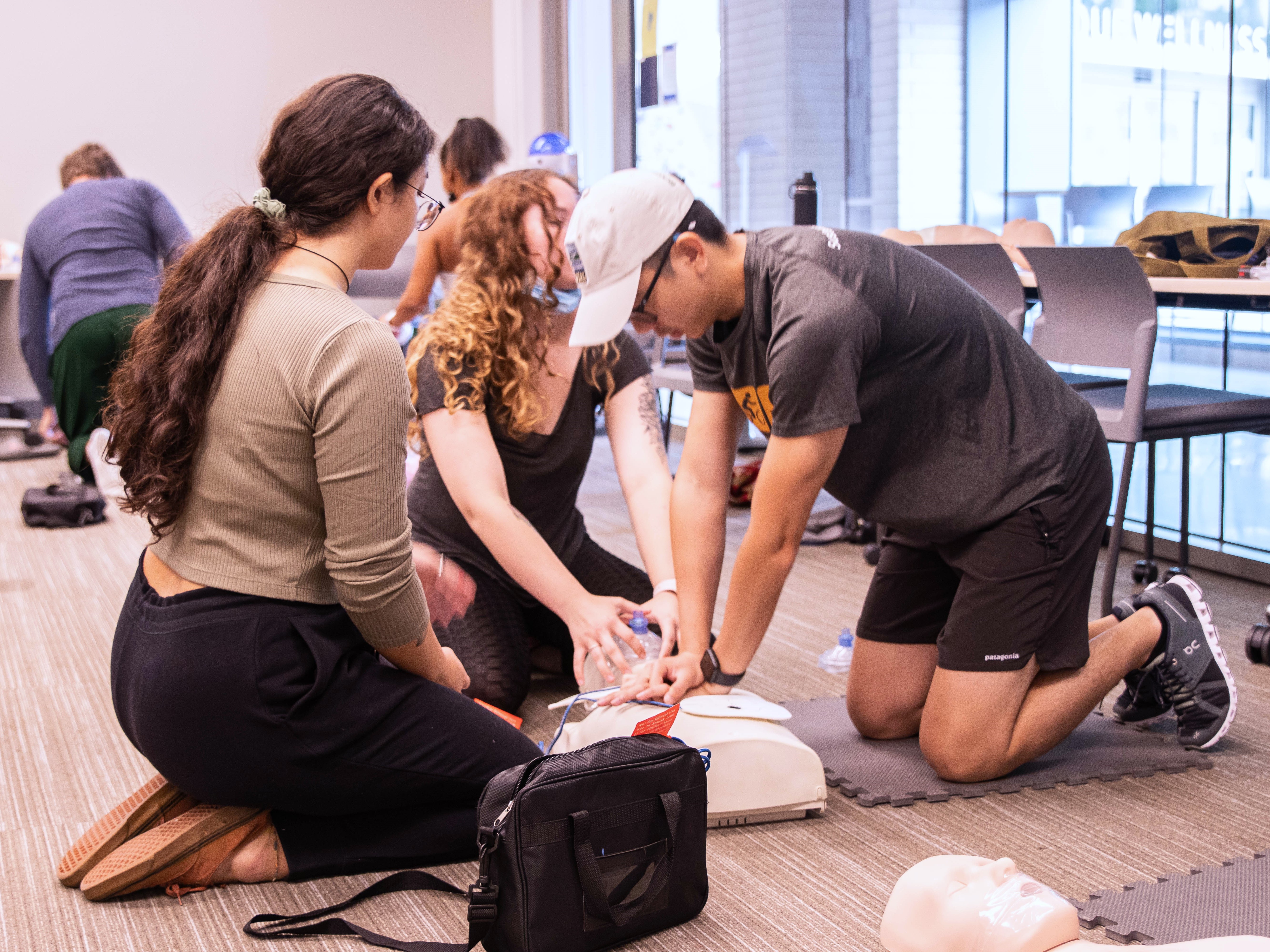 Students performing CPR on a dummy