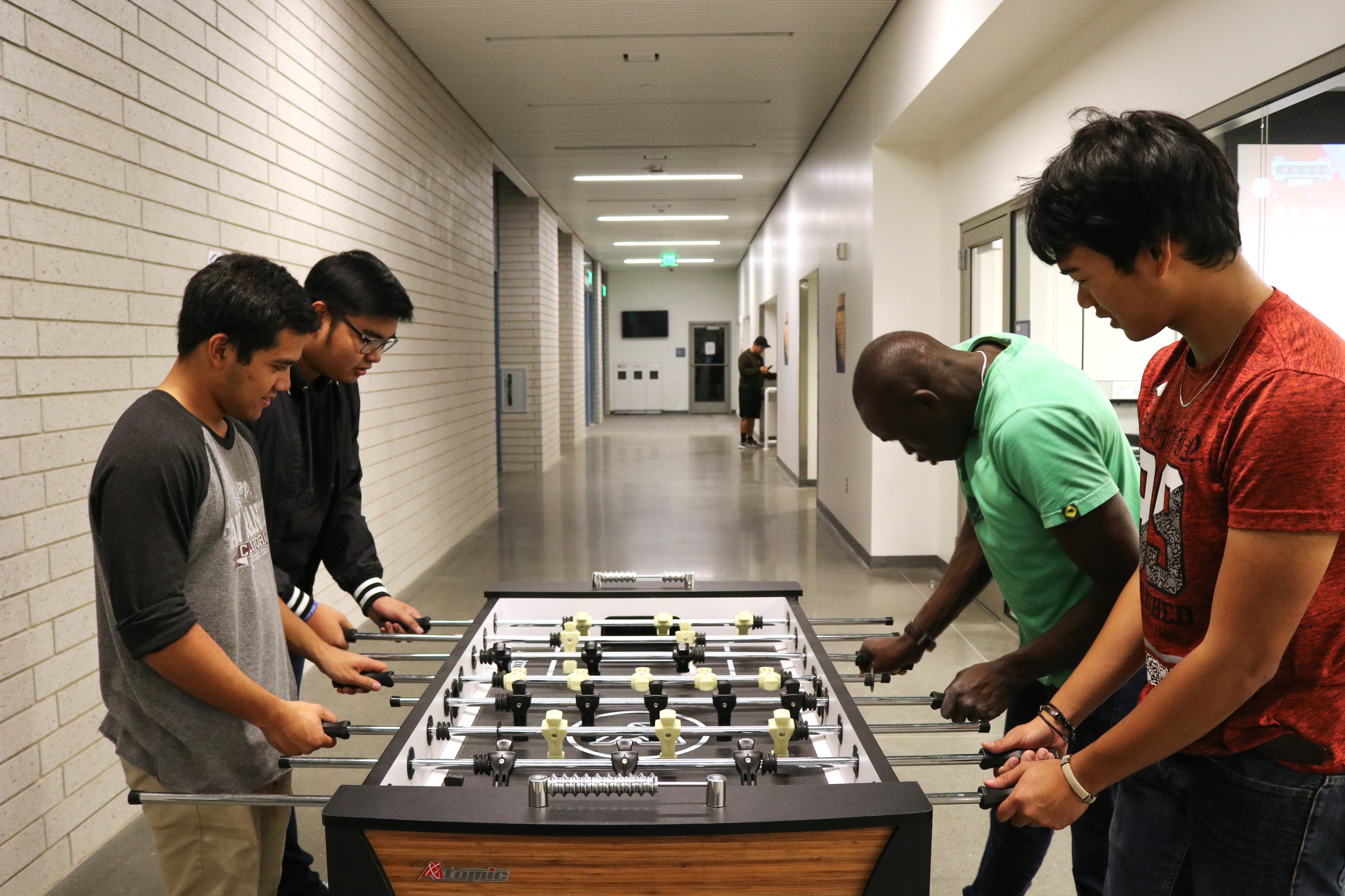 Students playing foosball