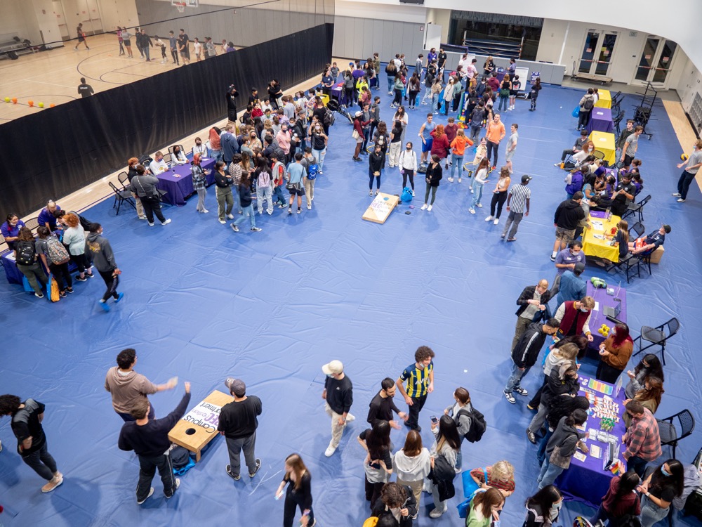 Participants at Rec the Night get information from students tabling