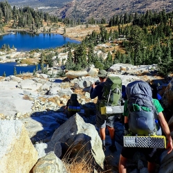 Students hiking down a hill