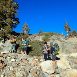 people backpacking in wilderness
